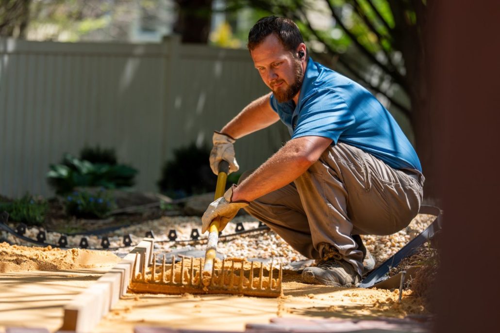 worker flattening soil