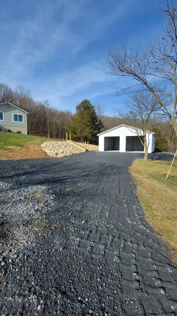 gravel driveway to white shed